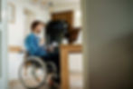 Young man in wheelchair sitting at home