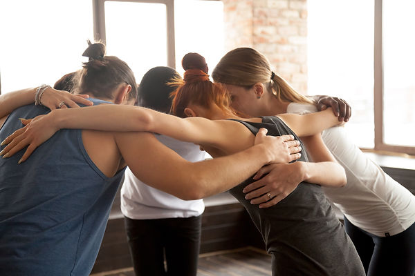 Young-people-embracing-in-circle-standing-together-group-unity-concept-922482666_5616x3744