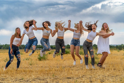Group of girls jumping in a field