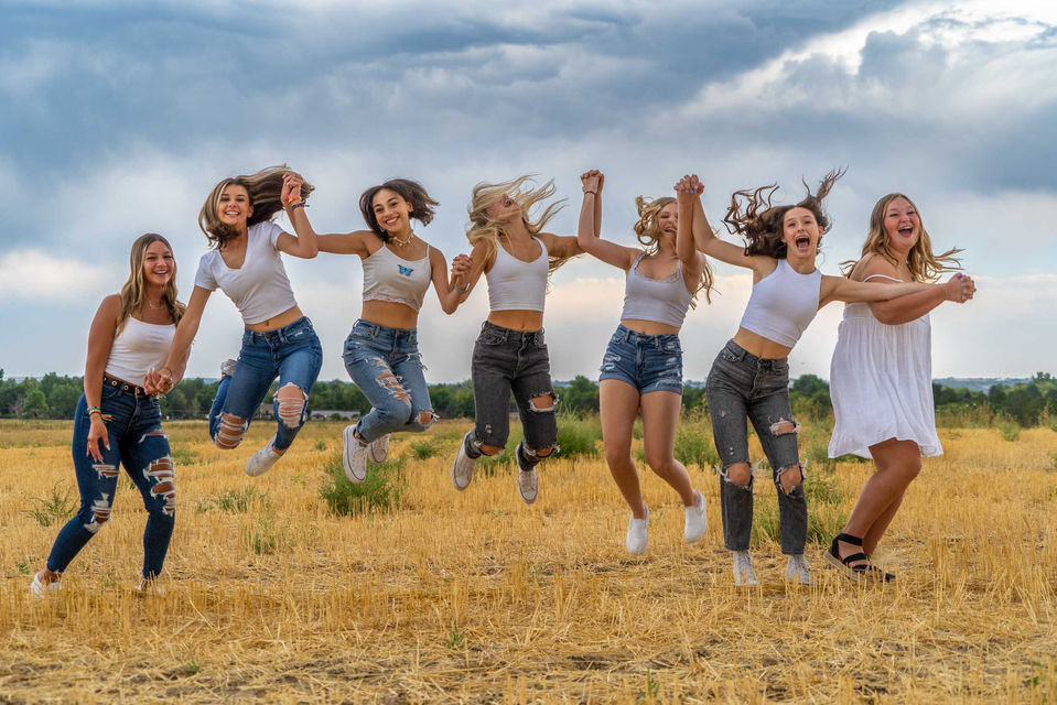 Group of girls jumping in a field