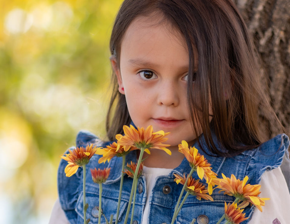 Girl holding orange flowers