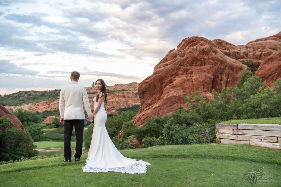 Bride and groom holding hands at their wedding, LW Productions