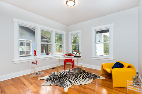 Bright room with hardwood floors, zebra rug, and yellow chair for Real Estate Photography by LW Productions