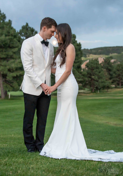 Couple holding hands on their wedding day