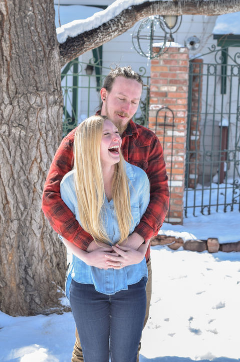Couple laughing and embracing outdoors in the snow