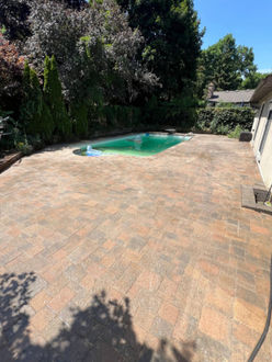 Interlock pool patio after sealing in Oakville Ontario with restored colour stabilized joints and professional seal finish