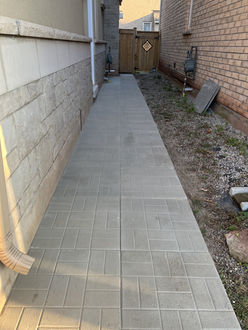 Interlock walkway after installation in Oakville Ontario with new pavers properly laid leveled and aligned creating a clean functional pathway
