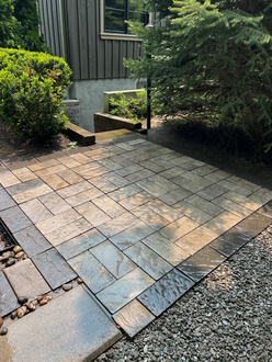 Slate-look interlock patio after pressure washing showing rich amber and charcoal tones fully restored