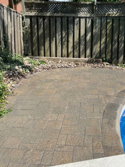 Interlock patio after re leveling in Oakville Ontario with pavers reset improved alignment and re sanded joints creating a clean uniform surface