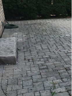 Interlock patio before re leveling in Oakville Ontario showing minor settling uneven surface and joint erosion