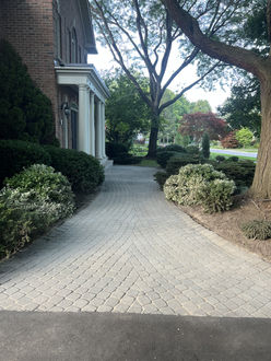Curved cobble fan pattern driveway with faded pavers before polymeric sanding and sealing Oakville