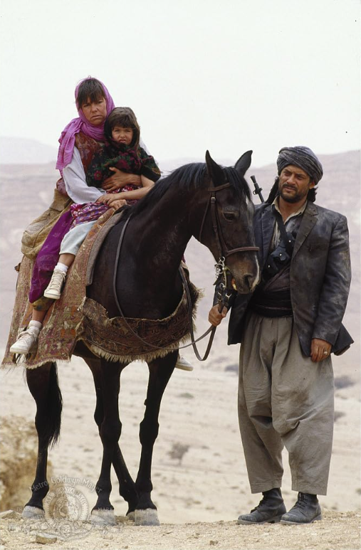 Betty and Mahtob Mahmoody ride a horse as a local smuggles them out of Iran.  Image courtesy of IMDb.com.