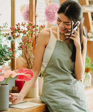 Woman on phone in flower shop
