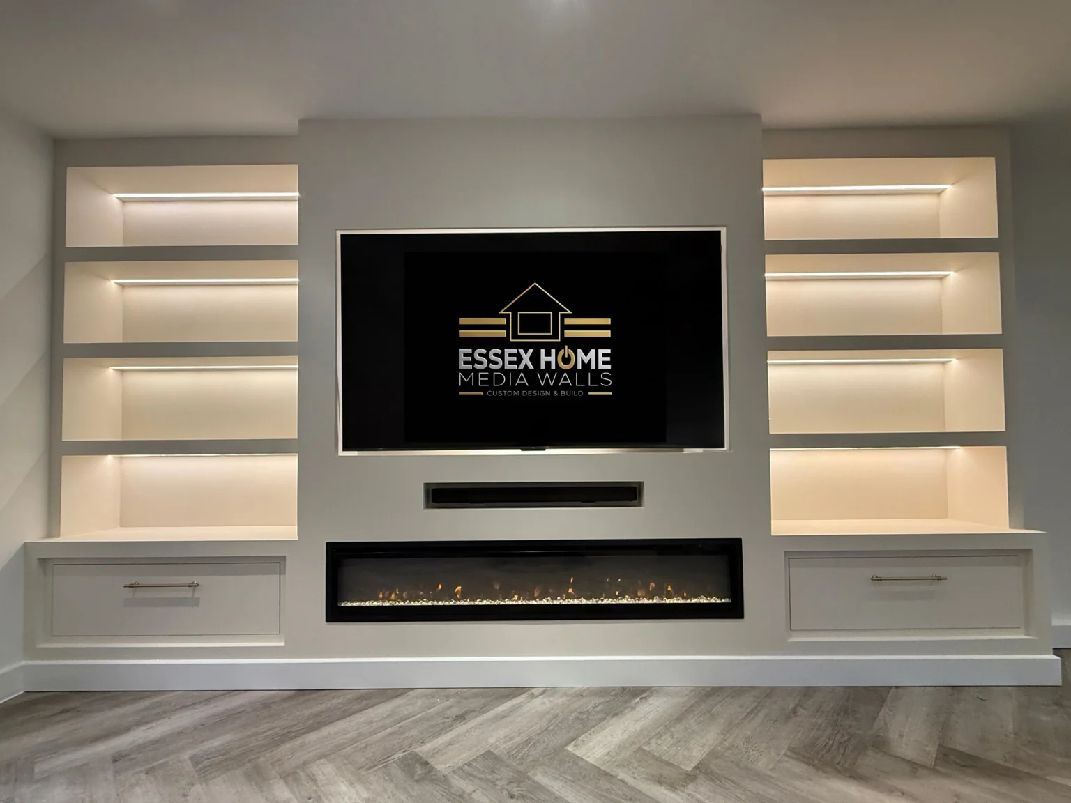 Media wall with six illuminated shelves, lower drawers and an electric fire
