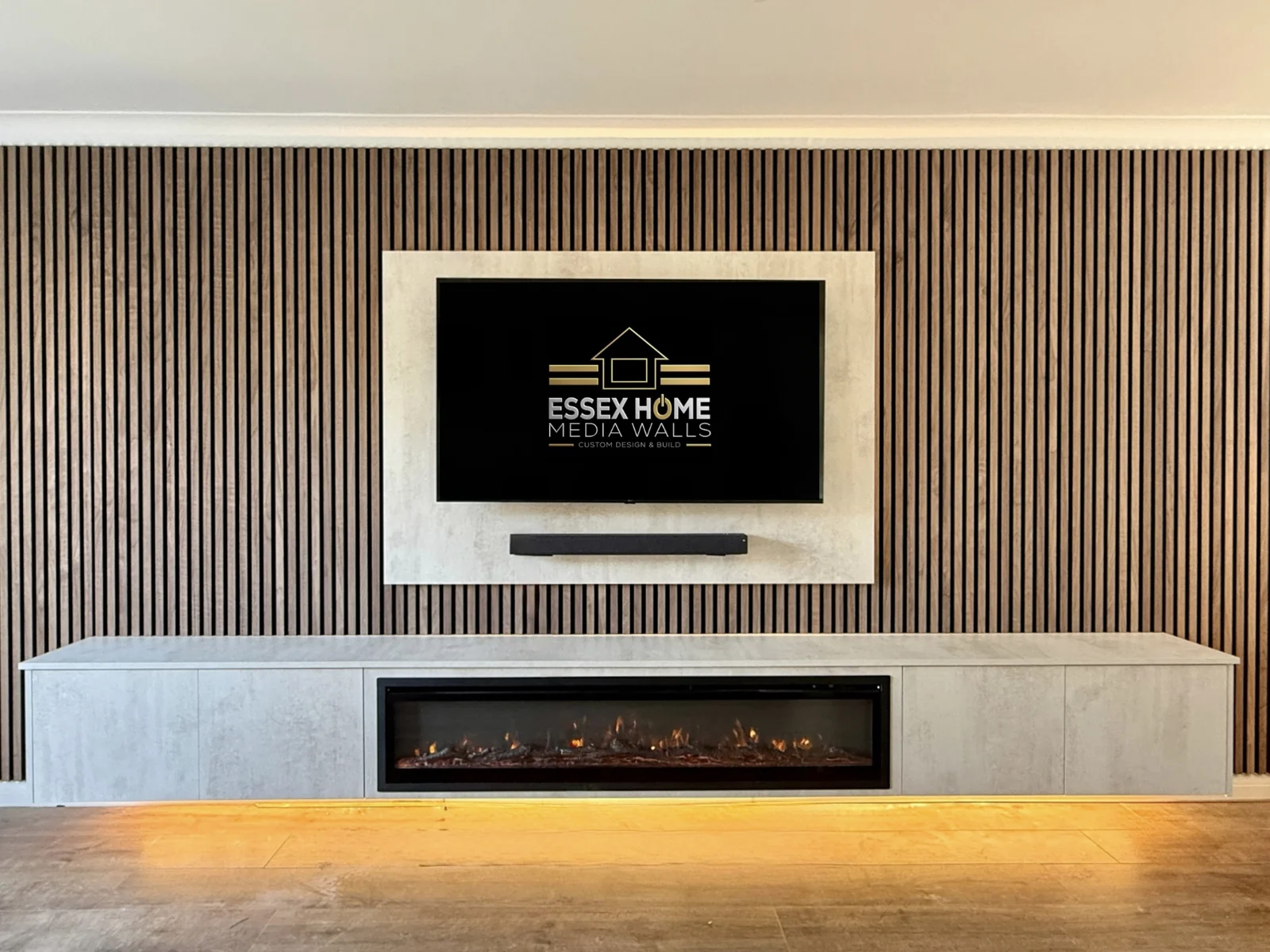 Slatted media wall with a pale TV surround and a long run of low cupboards