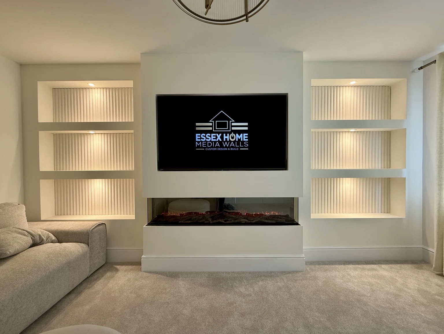 White media wall with six illuminated niches and a wide electric fire