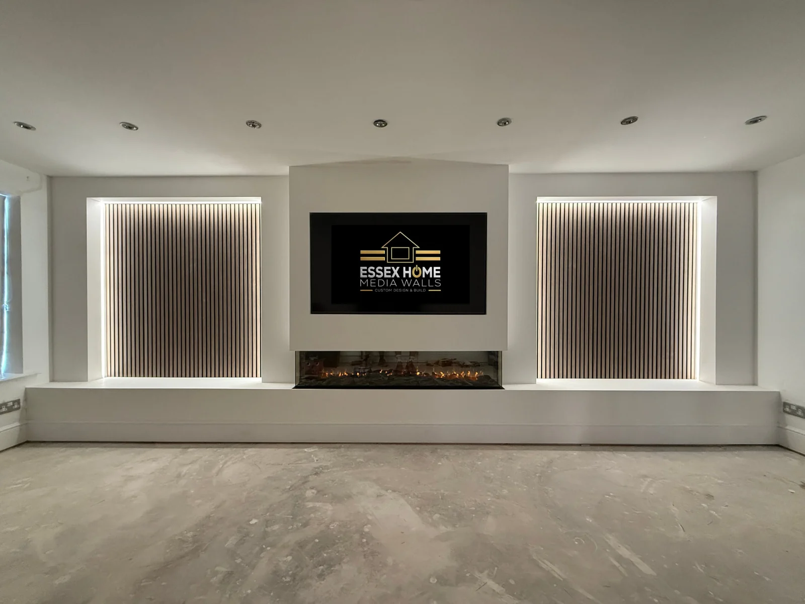 Wide media wall with illuminated vertical panels and a low hearth