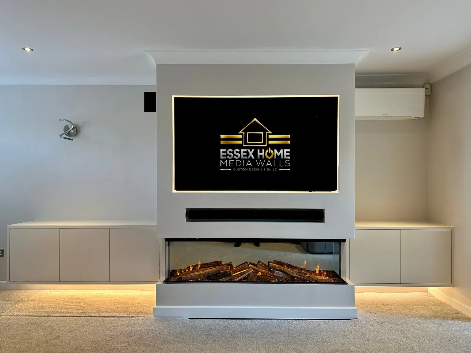 White media wall with floating side cupboards and a three-sided electric fire