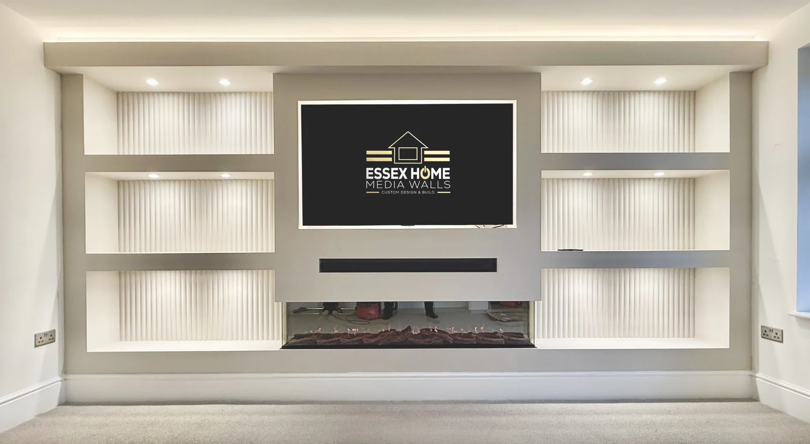 Wide white media wall with six ribbed illuminated niches and an electric fire