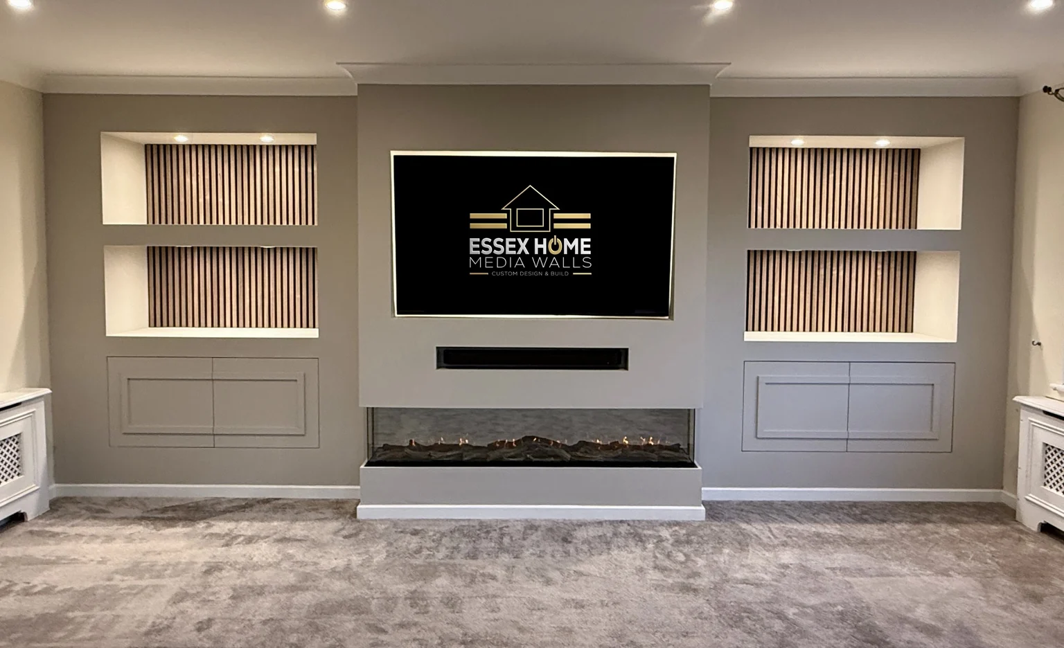 Grey media wall with timber-effect niches and panelled lower cupboards