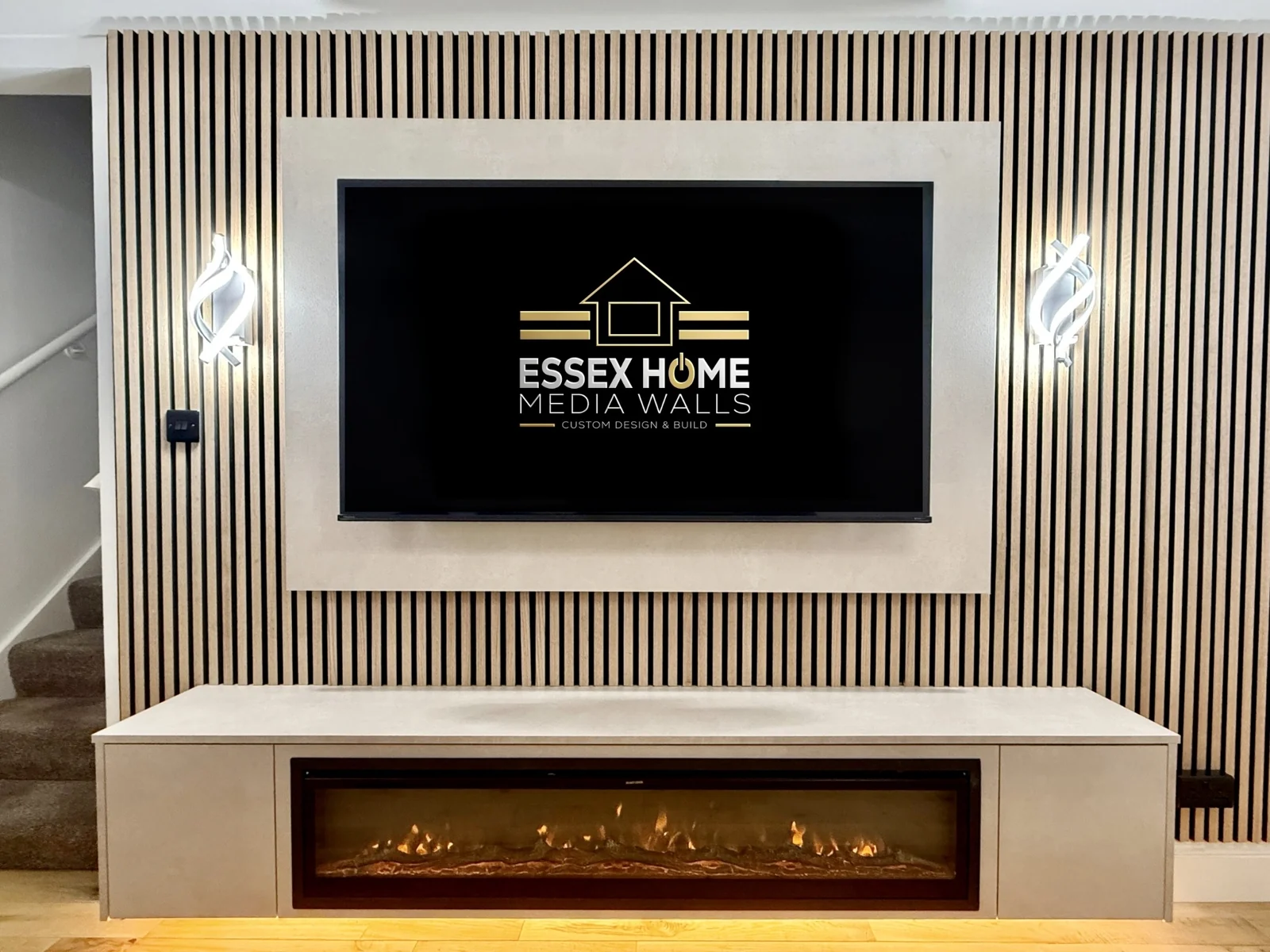 Timber-effect slat wall with a pale TV surround, wall lights and electric fire console