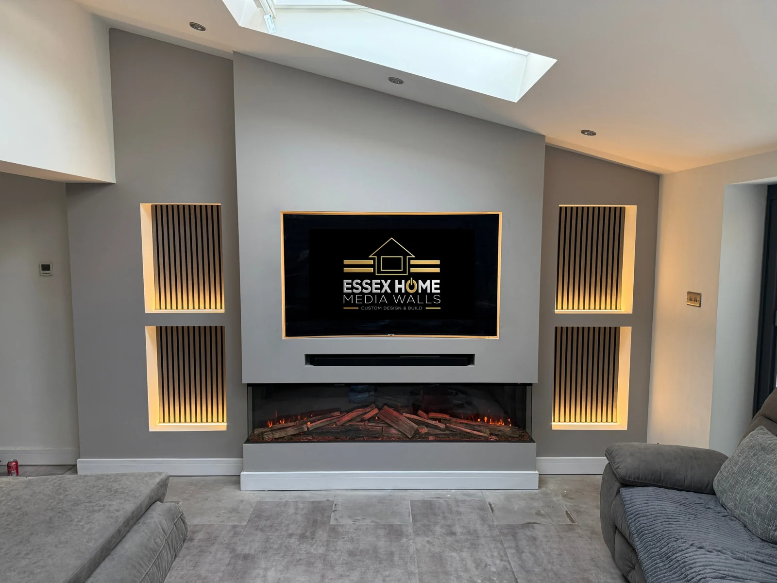 Media wall with timber-effect slatted niches beneath a rooflight