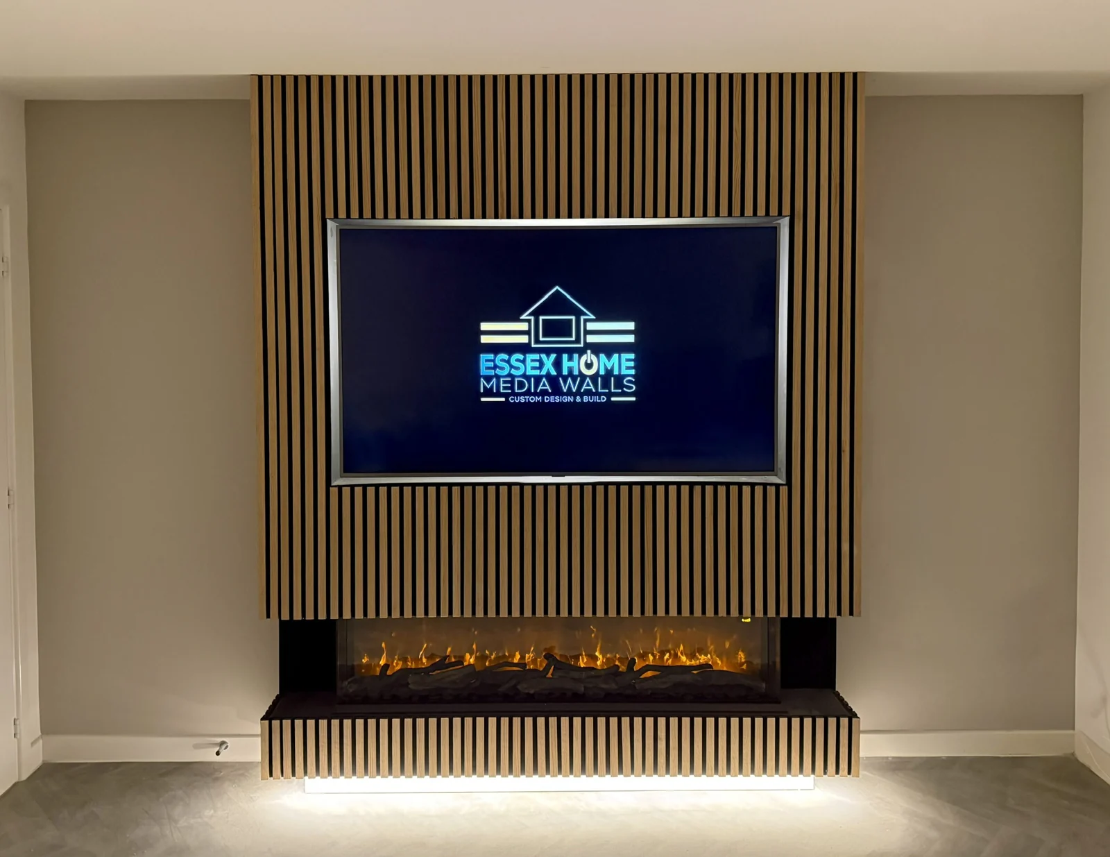 Timber slat feature with a wall-mounted television and electric fire