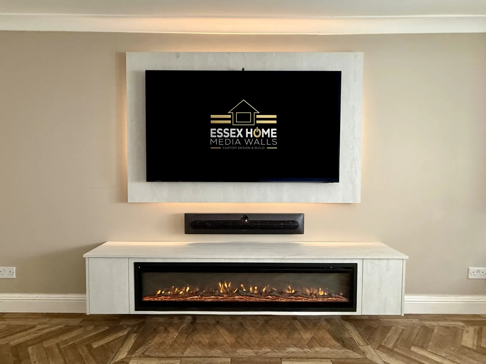 Light-coloured TV surround above an electric fire console