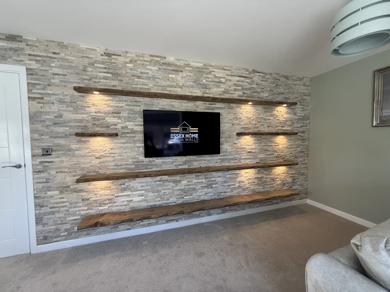 Stone-effect TV feature wall with horizontal illuminated recesses