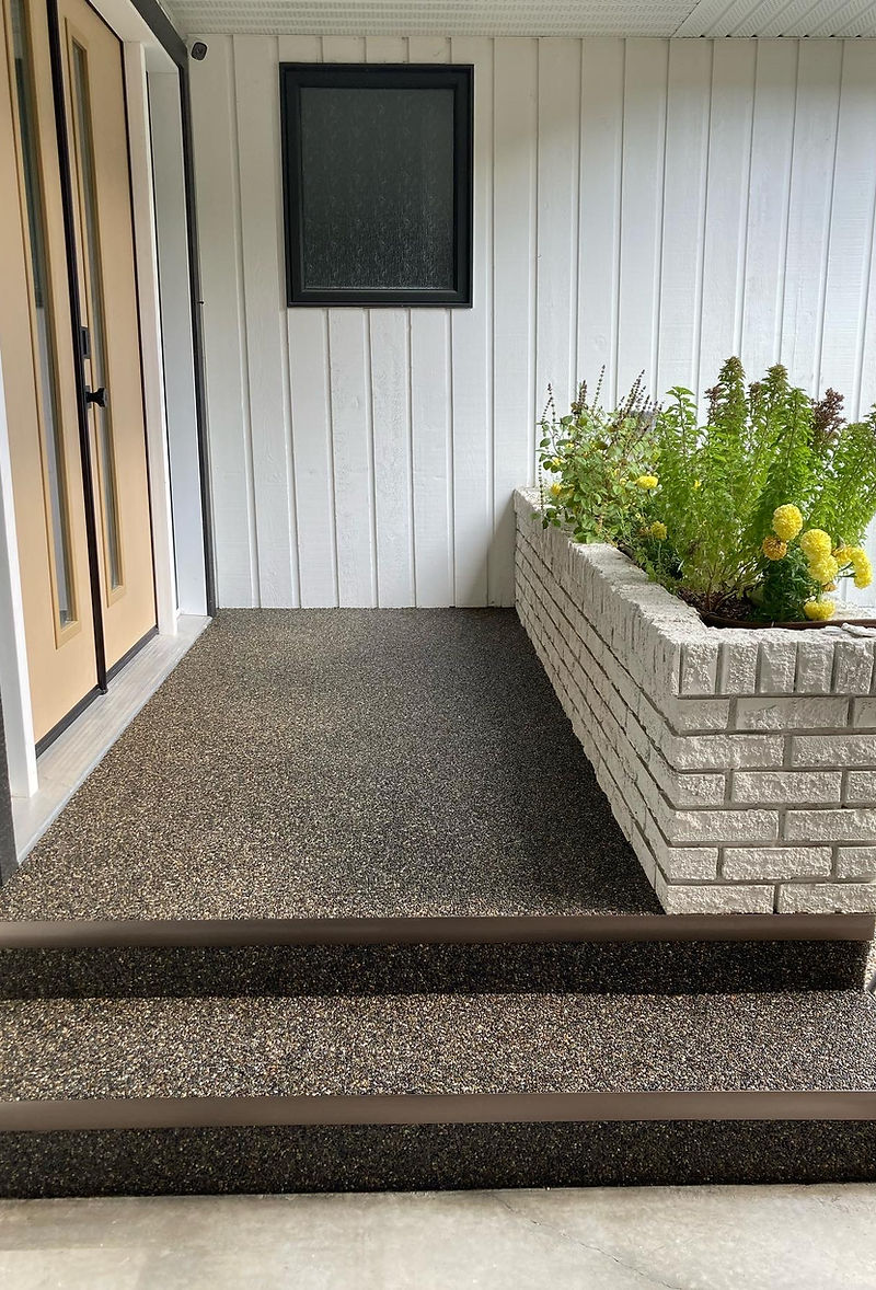 Stone aggregate on front entrance landing and steps — Front landing and steps with the Sierra Stone aggregate finish — the wraparound visual continuity across the riser and tread is what's hard to achieve with any other surface treatment.