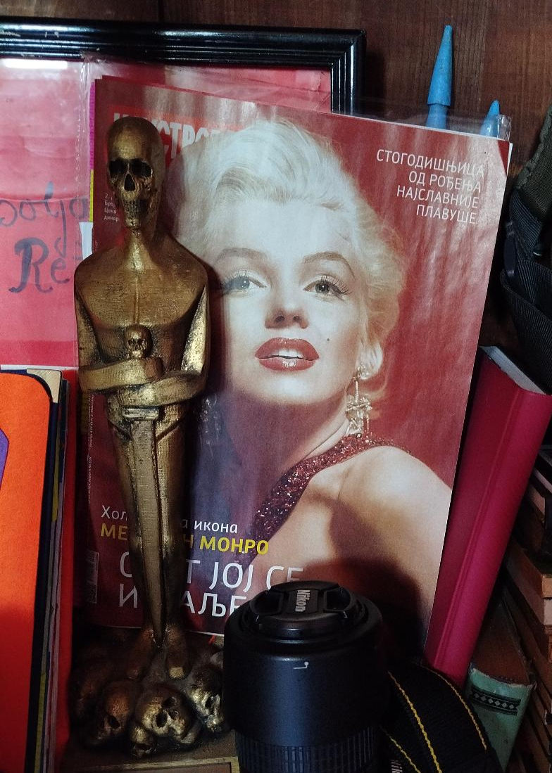 Photo by Jovana Dimitrijević of Marilyn Monroe on the cover of Serbian magazine Ilustrovana politika with Nikon camera and Best Direction Koskar award won by Jovana Dimitrijević for her film Lodger (2020) in the foreground.