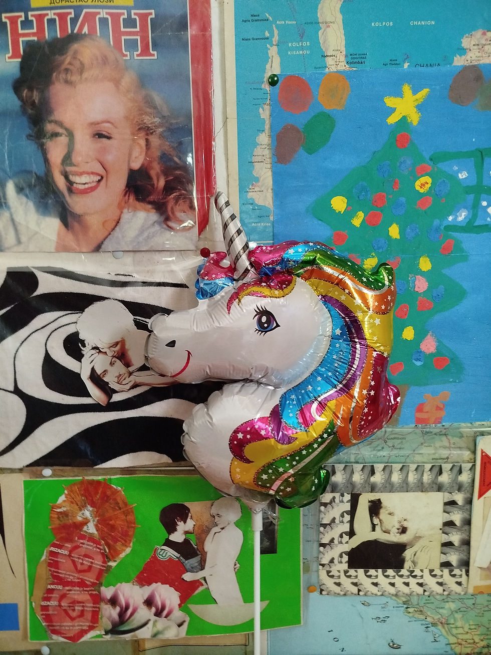 Photo by Jovana Dimitrijević of Marilyn Monroe on the cover of Serbian Nin magazine surrounded by poster designs for Jovana Dimitrijević's poster designs for her film Lodger (2020) pinned to the wall with a children's drawing of Christmas tree and unicorn head in the foreground.