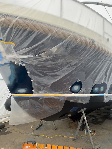 Steel boat undergoing paint repairs