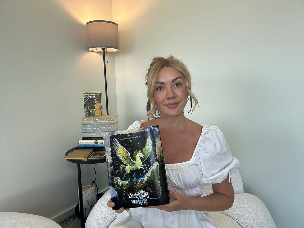 Emmy Lawless holding The Magician's Nephew by C.S Lewis