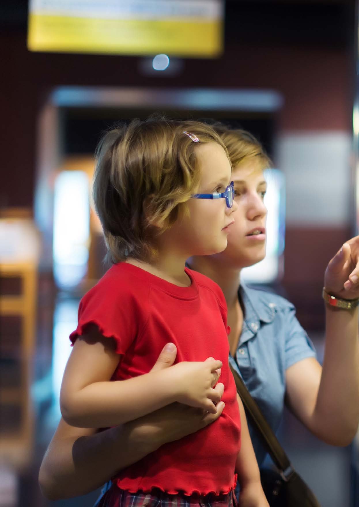 A parent and child looking at a museum display