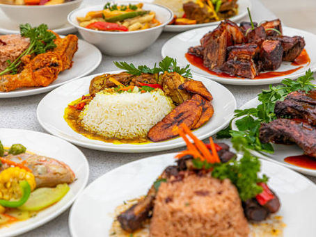 Authentic Jamaican dishes with rice, plantains, curry, and oxtail