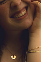 close up picture of a girl grabbing her face and scrunching it in joy at lake higgins marina, NC