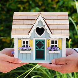two sets of hands carefully holding a home together