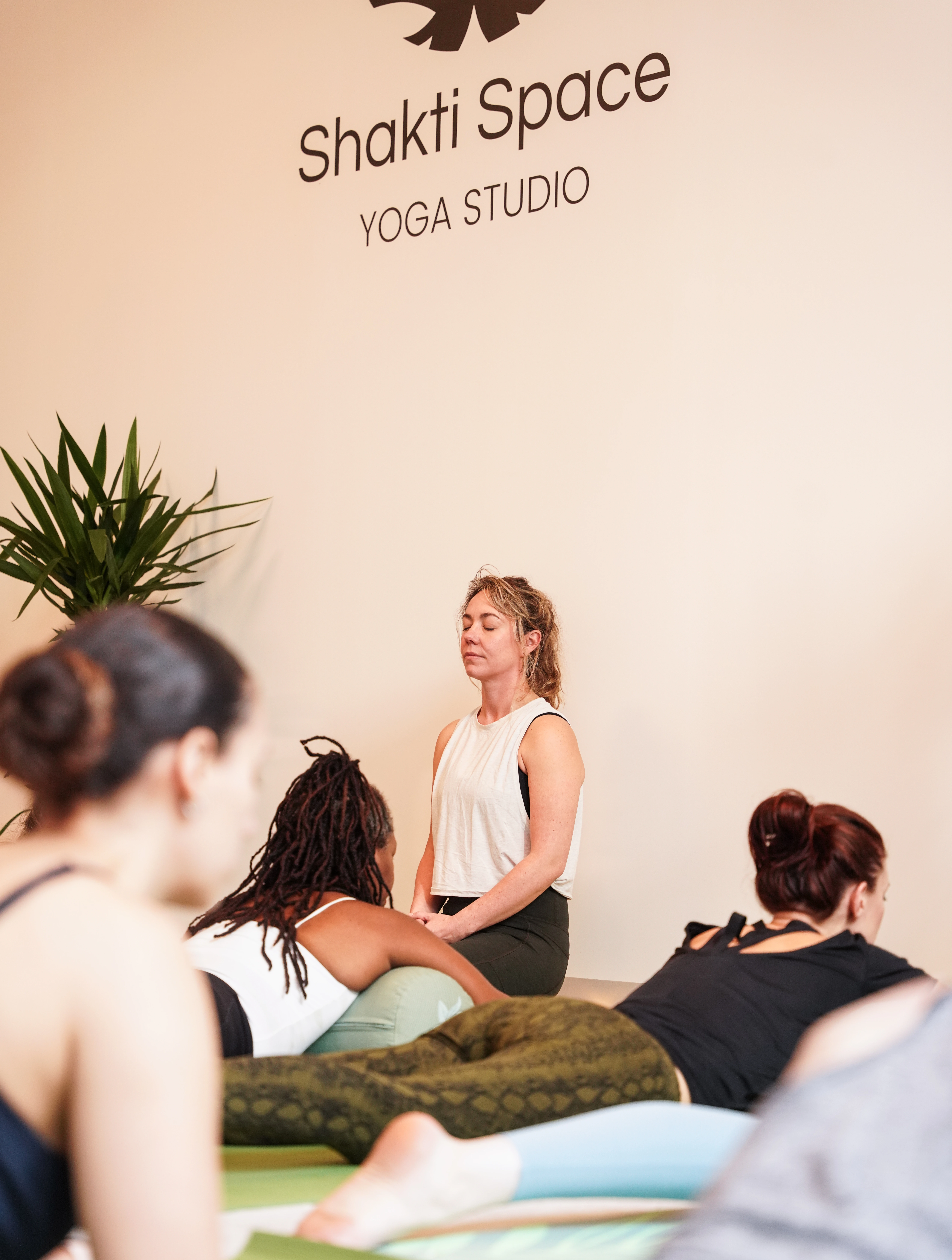 a yoga teacher speaking to class