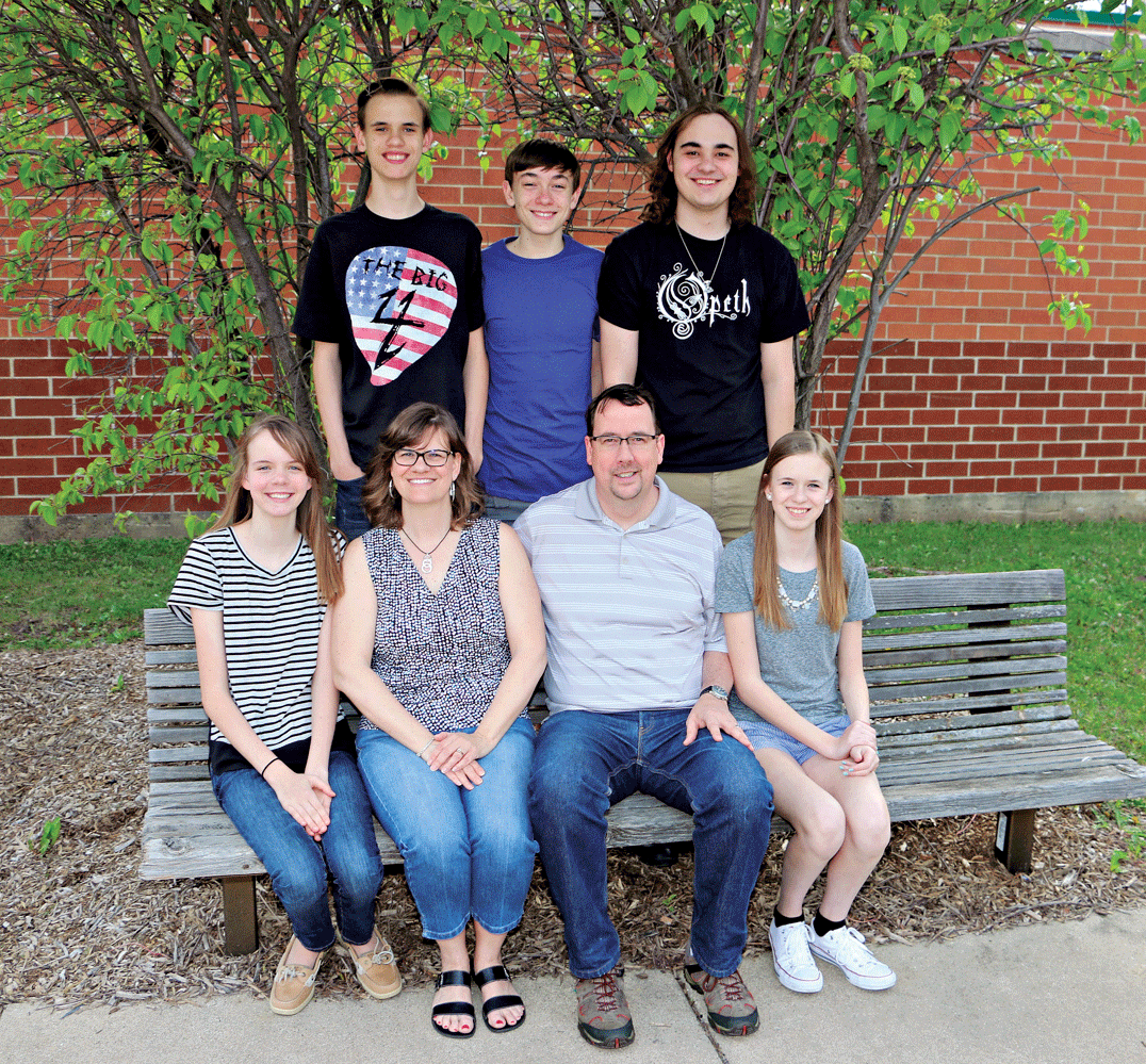 THE DRING FAMILY, WINFIELD/WHEATON 
 
 Making s'mores and hot dogs while hanging out with friends by the fire pit at home is one of the Dring’s favorite summer pastimes.  The kids also love to simply bike to the local Winfield CVS, Dairy Queen, or Dunkin Donuts and get sweet treats or drinks with their friends; or head over to Red Hawk Park in Carol Stream or Pleasant Hill School to play basketball or football with the gang.  Each summer the family also enjoys their annual tradition of attending the Illinois State Fair. There is never a lonely moment when you’re a Dring because there is usually a sibling to be found close by.  Tonya and Dan have five kids - a 19-year old son plus 15-year old quadruplets.  Add in a few friends and they can pretty much get a group discounted rate anywhere they go for summer fun!  The Drings have been living in Winfield for the past 6 years and love the small town homey feel.  Their favorite place to eat is Tony’s Steamers in Winfield where they can relish a great Vienna Beef hotdog, and they especially love Monday night’s Buy One, Get One Free Pizza at Evviva's Pizza in downtown Wheaton!   Nathan (19) enjoys his summer break from the College of Dupage hanging out at Mile Long Records in downtown Wheaton while Reagan (15) volunteers for FTEA (Friends for Therapeutic Equine Activities) and takes horseback riding lessons at Kingsway Farms in Winfield.  Caroline (15) and Heath (15) are very involved in all Bands at Wheaton North High School and Wil (15) participates in Cross Country.  Big family summer fun is sure to include weekly visits to College Church in Wheaton where the entire Dring family is very active!  Photos by Lynn Logan