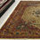 Thumbnail: This Persian rug features a striking medallion motif on a light background, gold borders.
