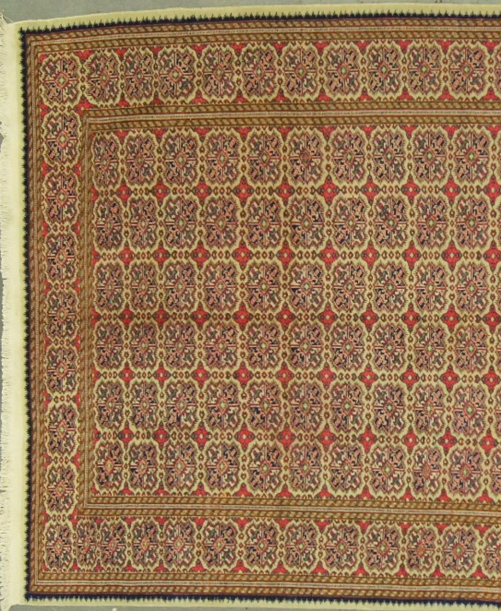 Thumbnail: This hand-knotted rug has a neutral color palette, making it easy to pair with any furniture or decor style.