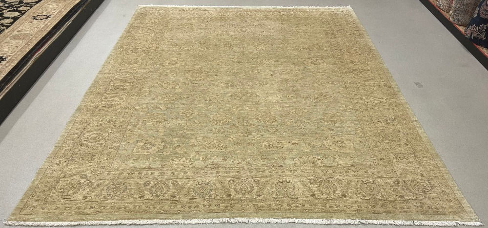 This Pakistani rug features an elegant design in a light green color.