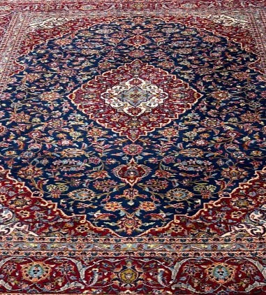 Thumbnail: This Persian Kashan rug features a striking medallion motif in beautiful red and blue colors.