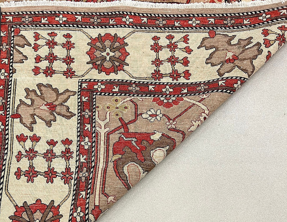 Thumbnail: This Persian rug features a striking geometric design in red brick color, tan background, ivory borders.