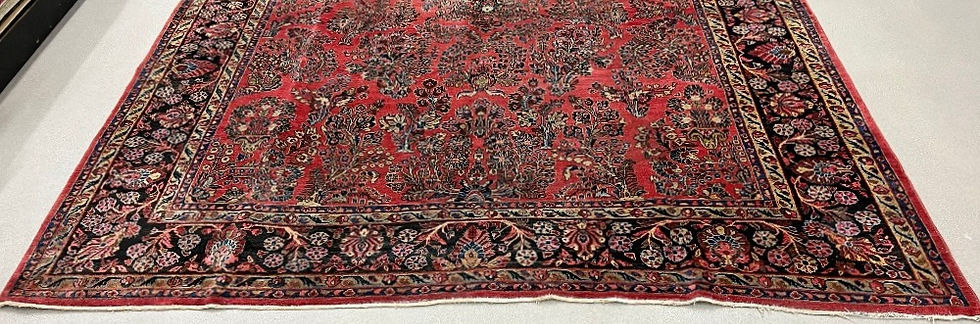 Thumbnail: This Persian Sarouk rug features intricate design in red and green colors.