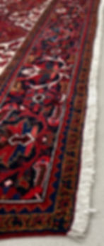 This Persian rug features a magnificent design in a gorgeous ruby red color.