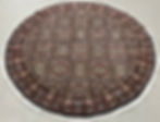 This Persian rug features elaborate floral design, cream background, brown borders.