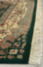 This Pakistani rug features a gorgeous pattern with flowers and a medallion in green color. green background, gold borders.