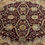 Thumbnail: This round India rug features striking combination of burgundy background and intricate design.